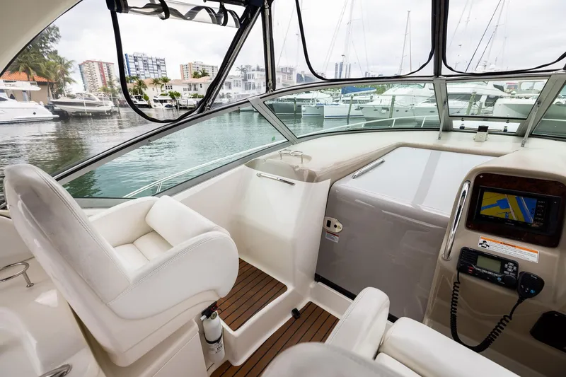 Slide: The Image of 2007 Sea Ray 340 Sundancer cockpit with navigation system, docked at marina. - 22