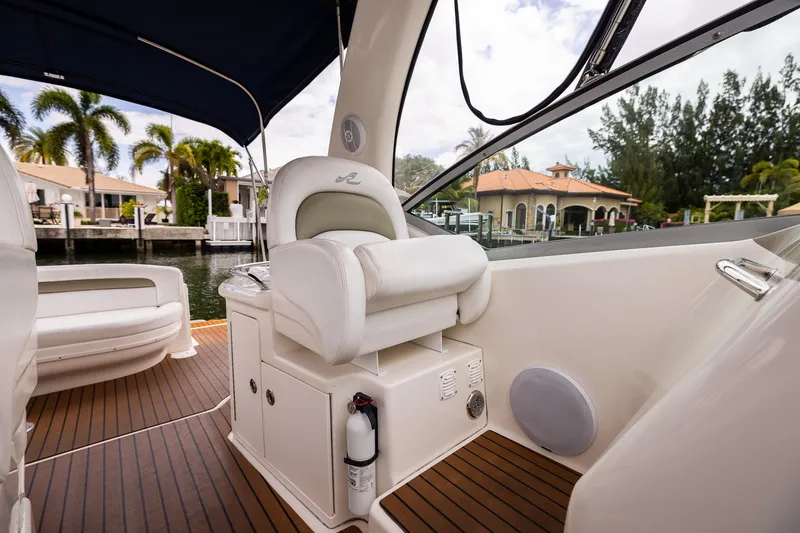 Slide: The Image of 2007 Sea Ray 340 Sundancer interior with white seating and waterfront view. - 23