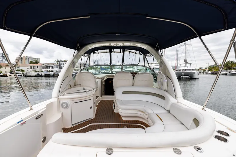 Slide: The Image of 2007 Sea Ray 340 Sundancer yacht interior with white seating and canopy, docked in marina. - 24