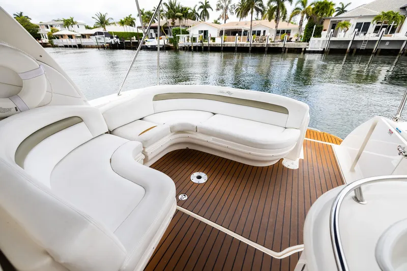 Slide: The Image of Luxurious 2007 Sea Ray 340 Sundancer boat interior with white seating and wooden deck. - 25