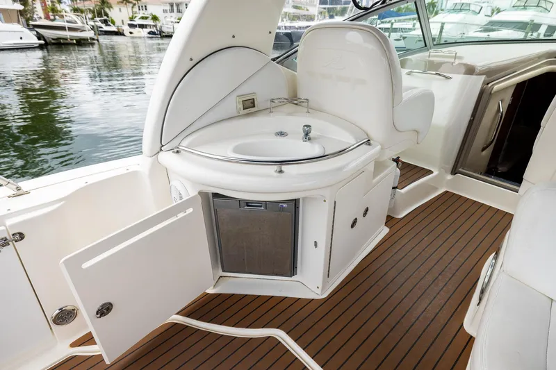 Slide: The Image of 2007 Sea Ray 340 Sundancer boat interior with sink and storage, docked at marina. - 28