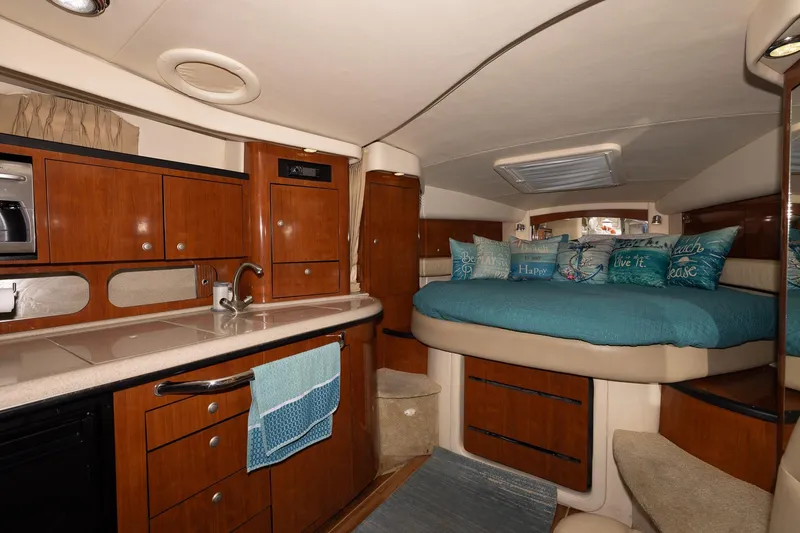 Slide: The Image of 2007 Sea Ray 340 Sundancer cabin interior with kitchenette and cozy sleeping area. - 31