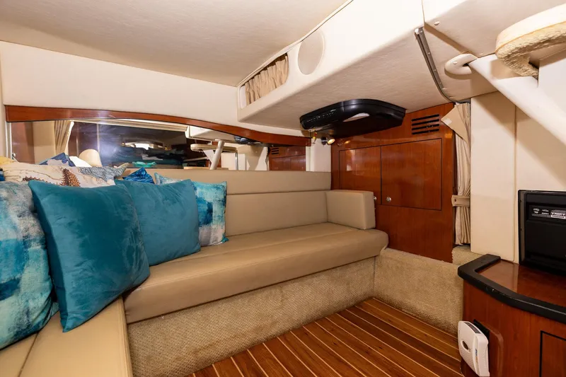 Slide: The Image of Interior of 2007 Sea Ray 340 Sundancer yacht with beige seating and blue cushions. - 36