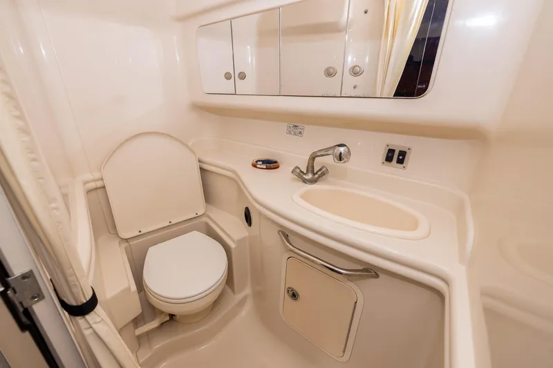 Slide: The Image of 2007 Sea Ray 340 Sundancer bathroom with toilet, sink, and mirrored cabinet. - 37