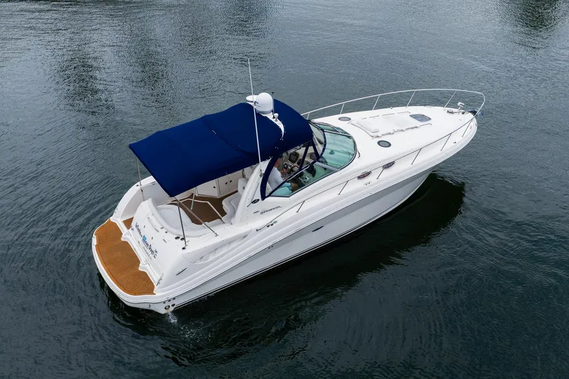 Slide: The Image of 2007 Sea Ray 340 Sundancer yacht with blue canopy cruising on calm water. - 4