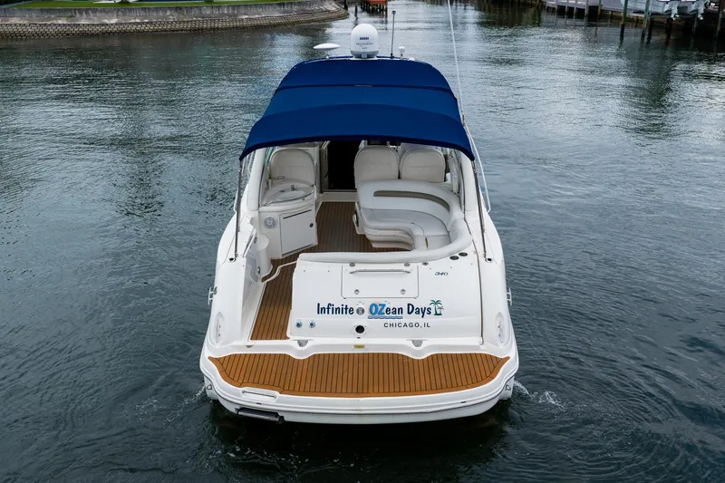 Slide: The Image of 2007 Sea Ray 340 Sundancer yacht with blue canopy on calm water. - 5