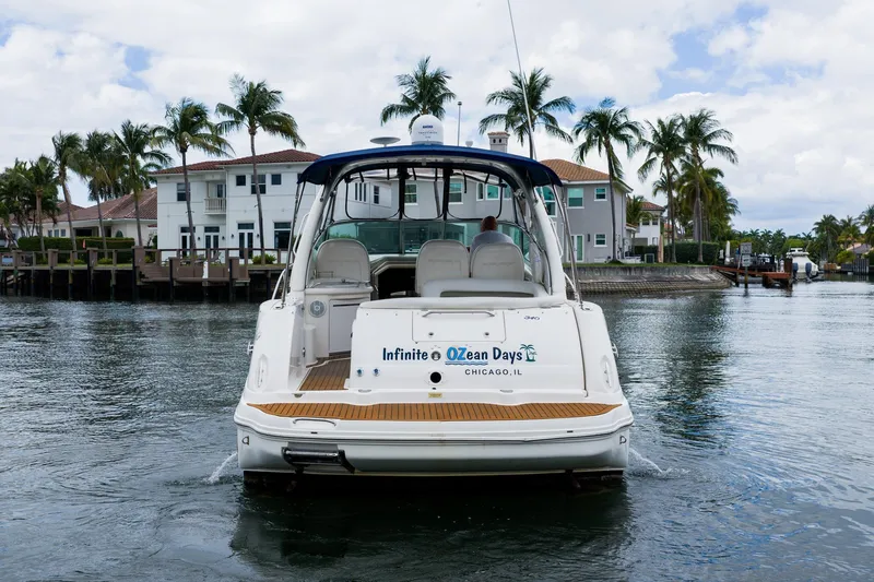 Slide: The Image of 2007 Sea Ray 340 Sundancer yacht on water, palm trees and houses in background. - 6