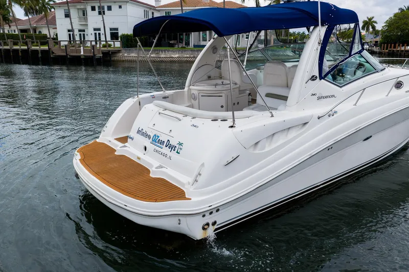 Slide: The Image of 2007 Sea Ray 340 Sundancer yacht with blue canopy docked in a marina. - 7