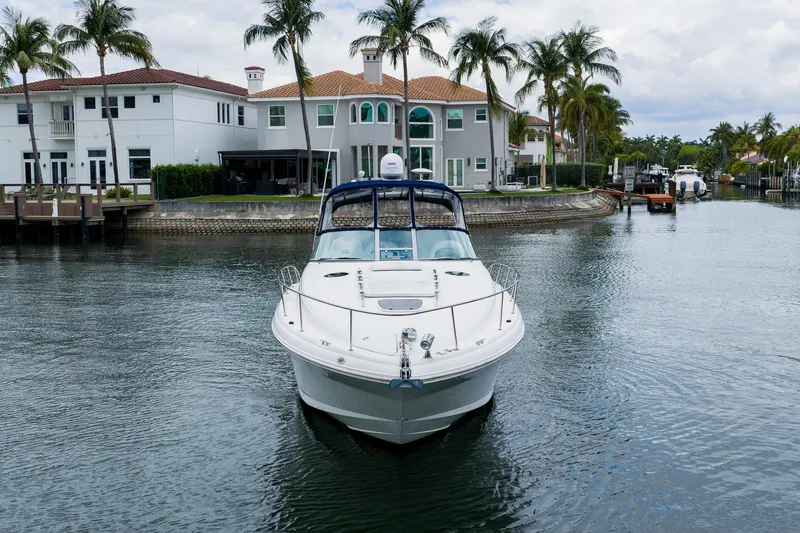 Slide: The Image of 2007 Sea Ray 340 Sundancer yacht docked in a scenic waterfront neighborhood. - 8