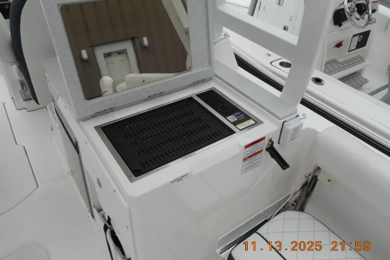 Slide: The Image of 2025 Sea Fox 288 Traveler boat interior with grill and seating area. - 10