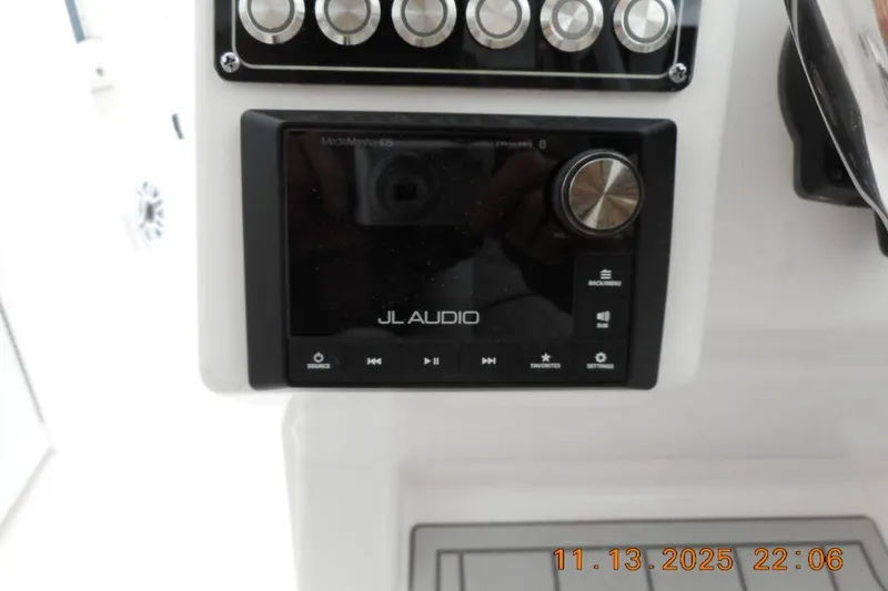 Slide: The Image of JL Audio system on 2025 Sea Fox 288 Traveler boat dashboard, featuring control knobs and display. - 14