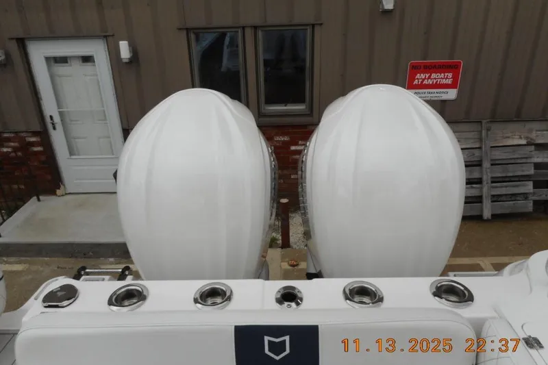 Slide: The Image of 2025 Sea Fox 288 Traveler boat engines and stern view at dockside. - 30