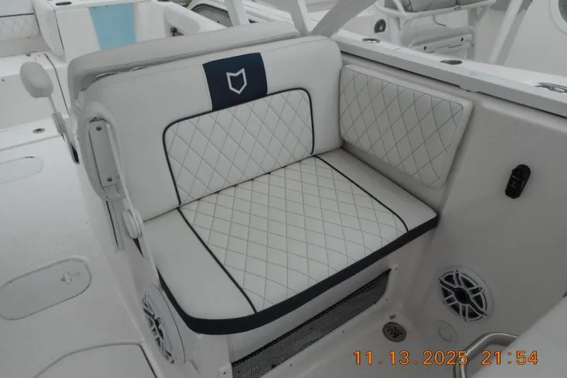 Slide: The Image of 2025 Sea Fox 288 Traveler boat interior with quilted seating and speaker detail. - 6