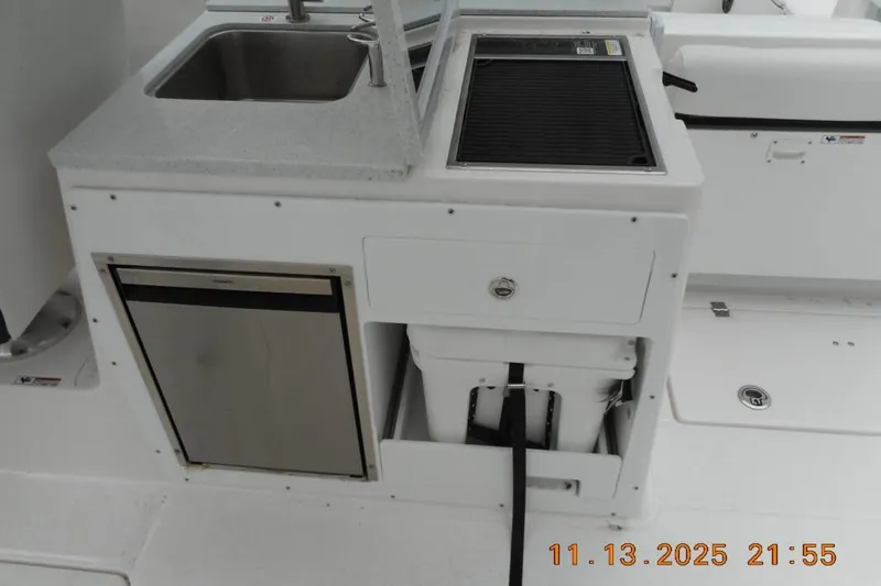 Slide: The Image of 2025 Sea Fox 288 Traveler boat kitchenette with sink, grill, and storage. - 9