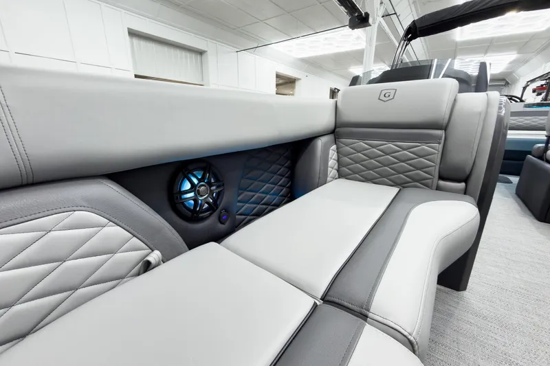 Slide: The Image of Luxurious interior of 2026 Godfrey Monaco 25' Tritoon with elegant seating and speaker system. - 14