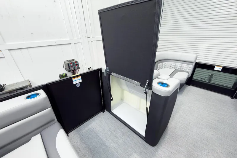 Slide: The Image of 2026 Godfrey Monaco 25' Tritoon interior with mid-table flip lounge feature. - 30
