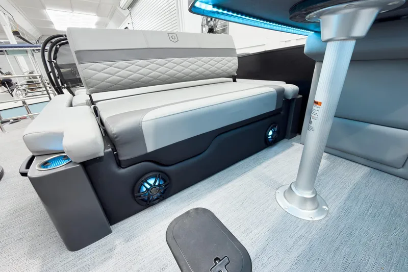 Slide: The Image of 2026 Godfrey Monaco 25' Tritoon interior with flip lounge seating and modern design features. - 39
