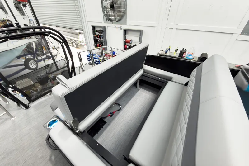 Slide: The Image of Interior of 2026 Godfrey Monaco 25' Tritoon with mid-table flip lounge seating. - 48
