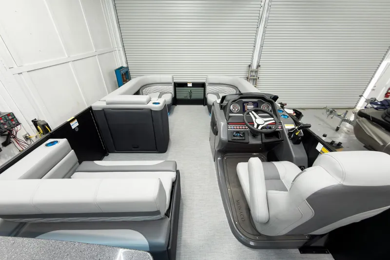 Slide: The Image of 2026 Godfrey Monaco 25' Tritoon interior with mid-table flip lounge and modern helm. - 56