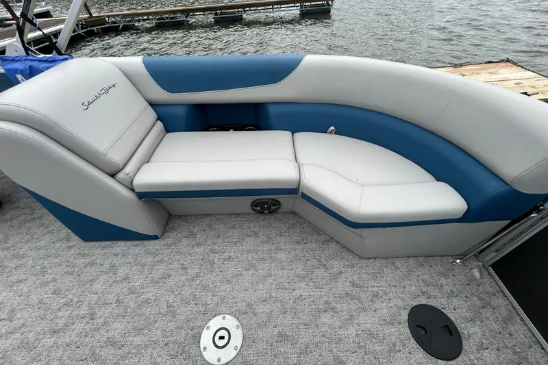 Slide: The Image of Luxurious seating on 2025 Southbay 224RSLE275 pontoon boat, featuring blue and gray upholstery. - 12