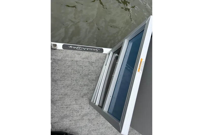 Slide: The Image of 2025 Southbay 224RSLE275 boat deck with open hatch, near water surface. - 29
