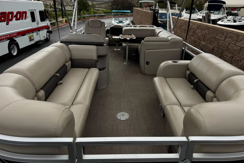 Slide: The Image of 2024 Sun Tracker SportFish 22 DLX pontoon boat with spacious seating and modern design. - 10