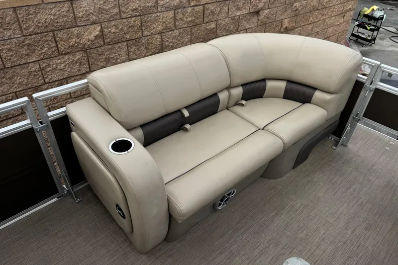 Slide: The Image of 2024 Sun Tracker SportFish 22 DLX boat seating with beige upholstery and cup holder. - 12