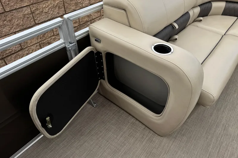 Slide: The Image of 2024 Sun Tracker SportFish 22 DLX boat seat with open storage compartment and cup holder. - 13