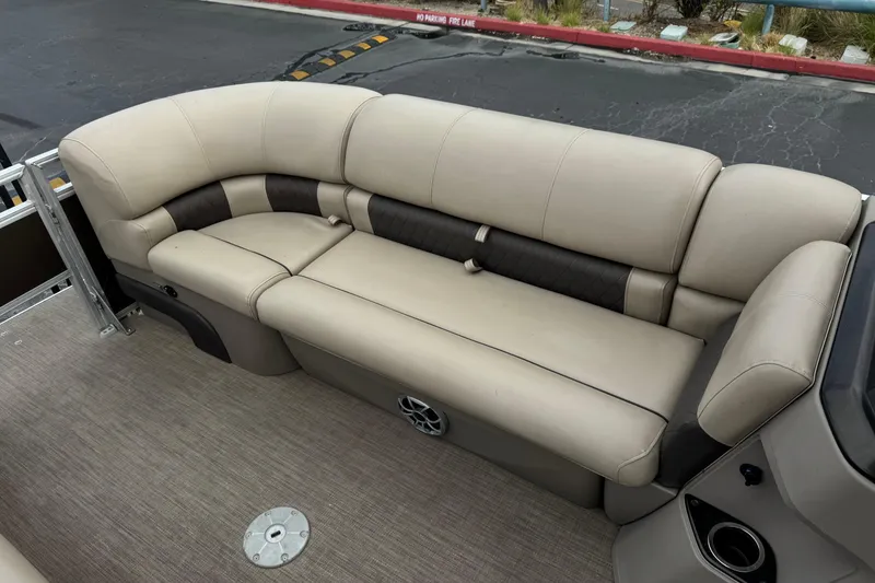 Slide: The Image of 2024 Sun Tracker SportFish 22 DLX pontoon boat with beige seating and carpeted floor. - 14