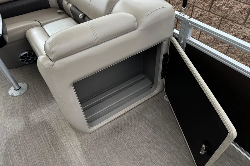Slide: The Image of 2024 Sun Tracker SportFish 22 DLX boat interior storage compartment with open door. - 16