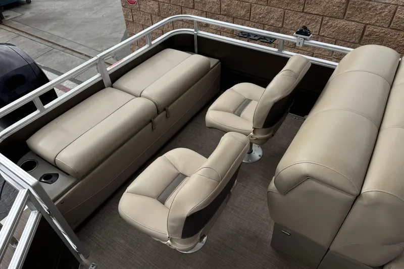 Slide: The Image of 2024 Sun Tracker SportFish 22 DLX interior with beige seating and cup holders. - 19