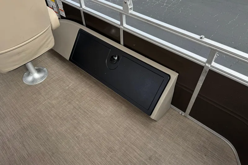 Slide: The Image of 2024 Sun Tracker SportFish 22 DLX interior with seating and storage compartment. - 24
