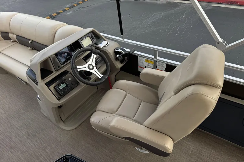 Slide: The Image of 2024 Sun Tracker SportFish 22 DLX boat interior with steering console and comfortable seating. - 26