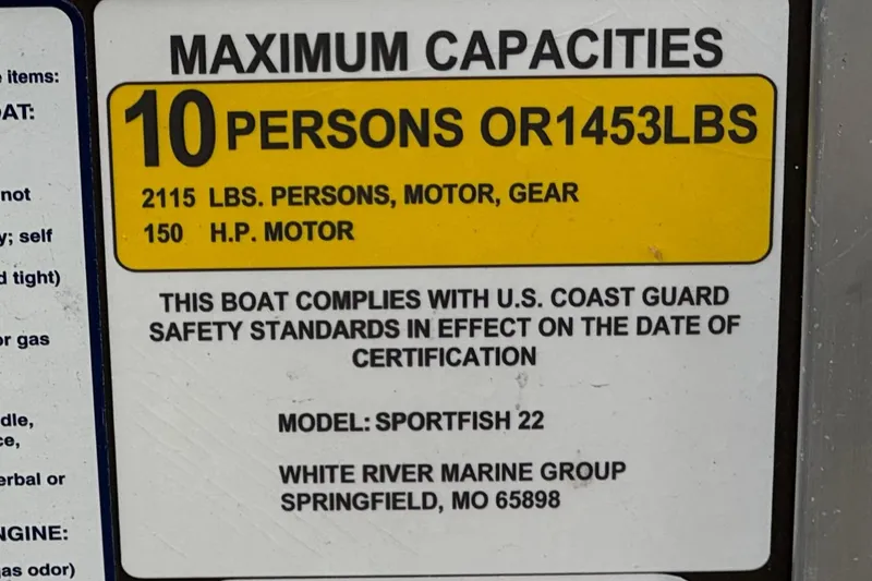 Slide: The Image of 2024 Sun Tracker SportFish 22 DLX capacity label, 10 persons or 1453 lbs, 150 HP motor. - 35
