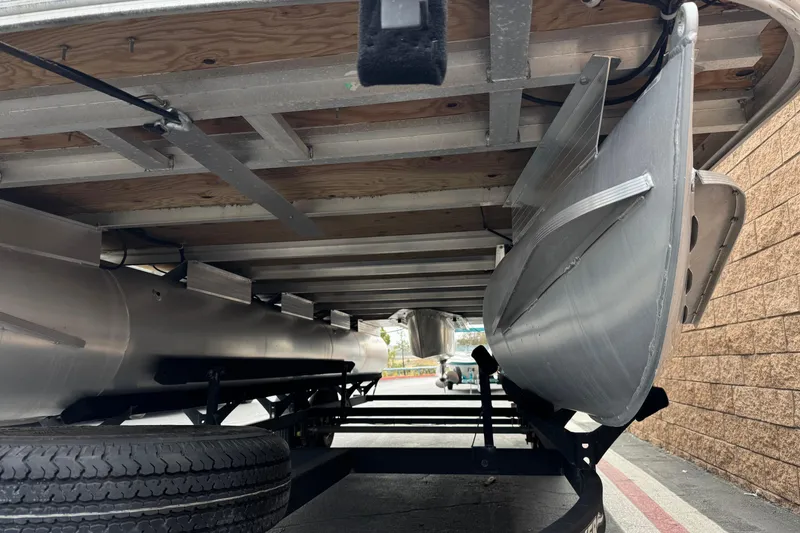 Slide: The Image of Underneath view of a 2024 Sun Tracker SportFish 22 DLX pontoon boat on a trailer. - 5