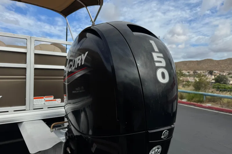 Slide: The Image of 2024 Sun Tracker SportFish 22 DLX with Mercury 150 outboard motor, scenic background. - 7