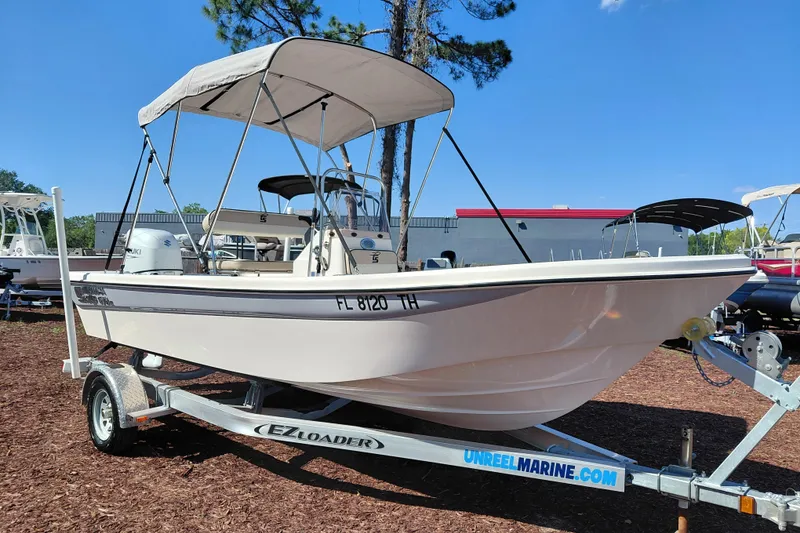 The Image of 2022 Carolina Skiff 178 JLS boat on trailer with canopy, parked outdoors. - 1