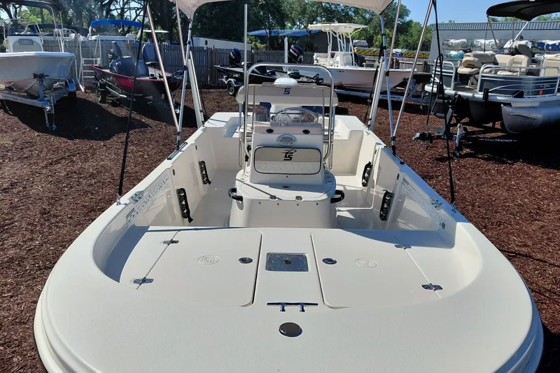 Slide: The Image of 2022 Carolina Skiff 178 JLS boat with open deck and seating, displayed outdoors. - 12