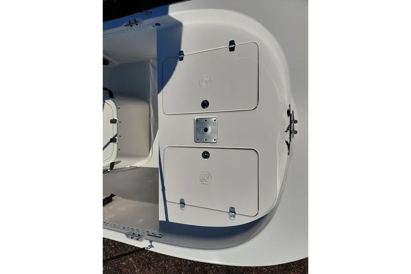 Slide: The Image of 2022 Carolina Skiff 178 JLS boat deck with storage compartments and latch details. - 13