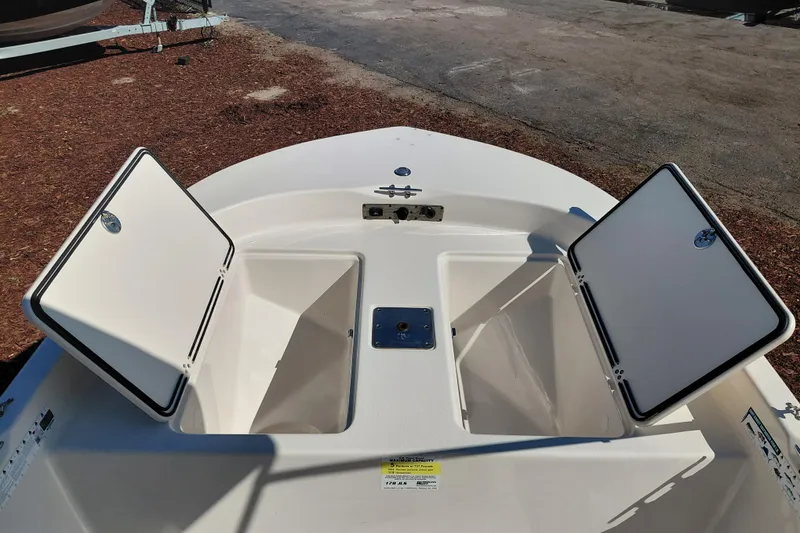 Slide: The Image of 2022 Carolina Skiff 178 JLS boat with open storage compartments on deck. - 17