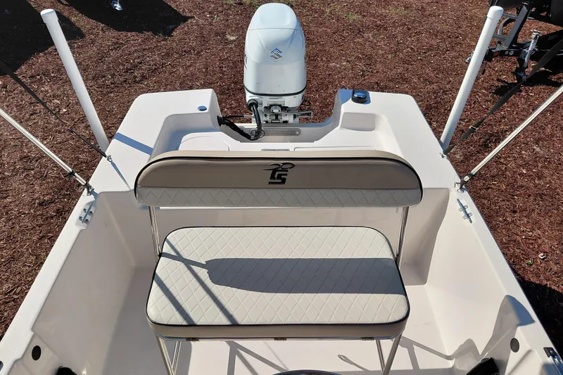 Slide: The Image of 2022 Carolina Skiff 178 JLS boat interior with seating and motor, viewed from above. - 23