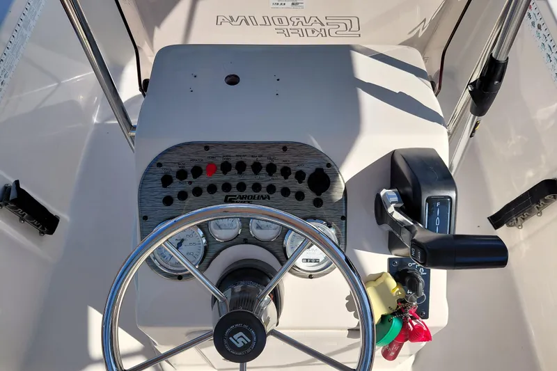 Slide: The Image of 2022 Carolina Skiff 178 JLS boat console with steering wheel and control panel. - 26