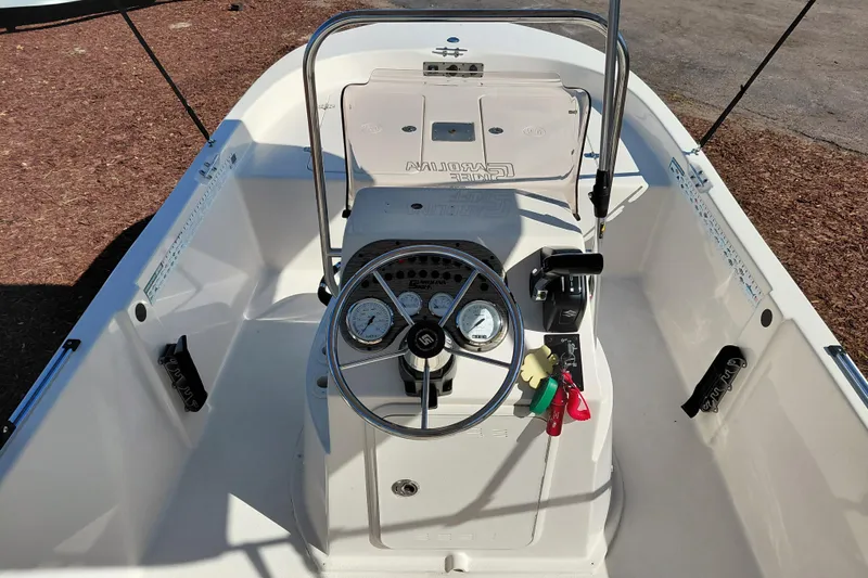 Slide: The Image of 2022 Carolina Skiff 178 JLS boat console with steering wheel and gauges. - 27