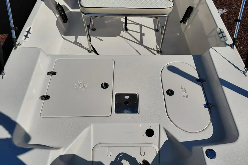 Slide: The Image of 2022 Carolina Skiff 178 JLS boat deck with storage compartments and seating. - 33