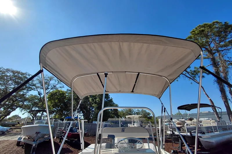 Slide: The Image of 2022 Carolina Skiff 178 JLS boat with canopy under clear blue sky. - 38