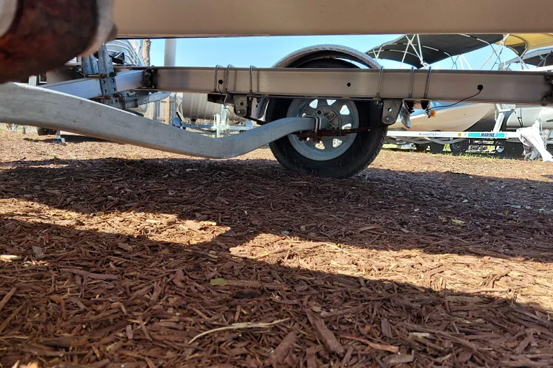 Slide: The Image of Trailer under a 2022 Carolina Skiff 178 JLS boat, parked on mulch. - 39