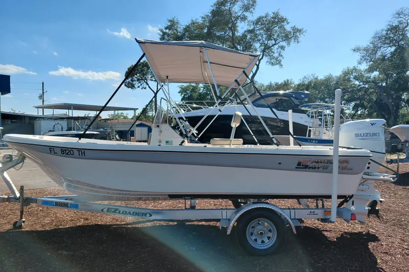 Slide: The Image of 2022 Carolina Skiff 178 JLS boat on trailer, featuring a Suzuki outboard motor. - 4
