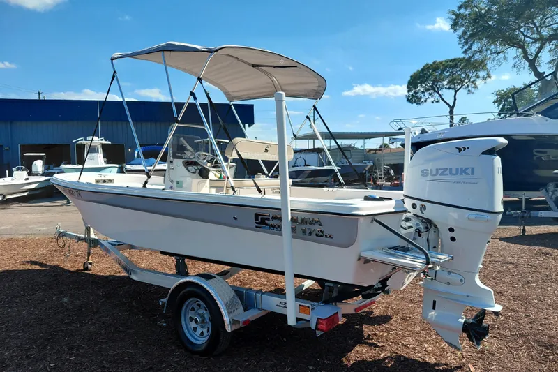 Slide: The Image of 2022 Carolina Skiff 178 JLS boat with Suzuki outboard motor on trailer. - 5