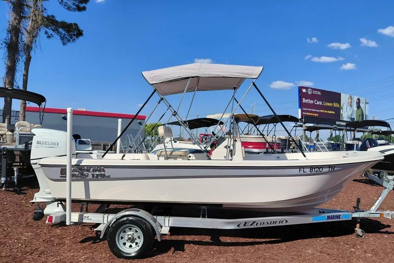 Slide: The Image of 2022 Carolina Skiff 178 JLS boat on trailer, featuring Suzuki outboard motor. - 8