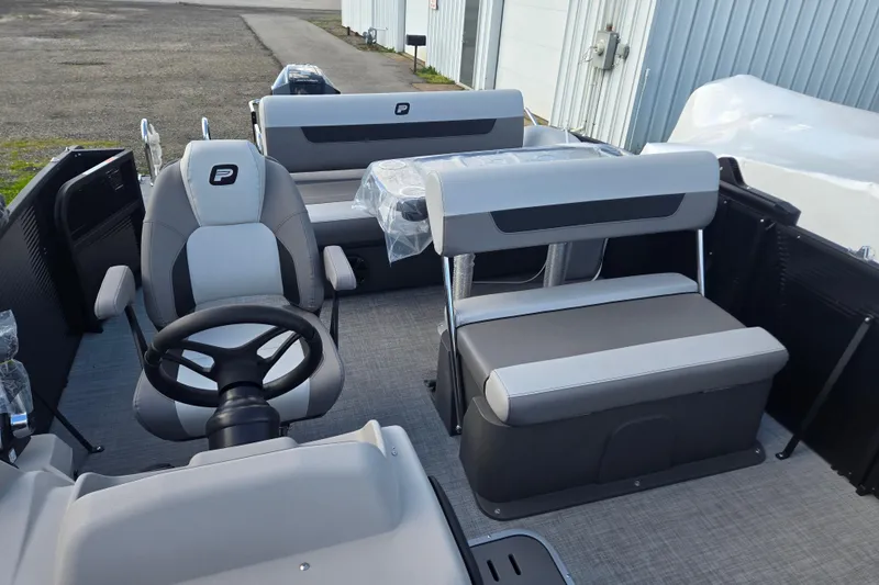 Slide: The Image of 2026 Princecraft Vectra 23 RL pontoon boat interior with modern seating and steering wheel. - 6